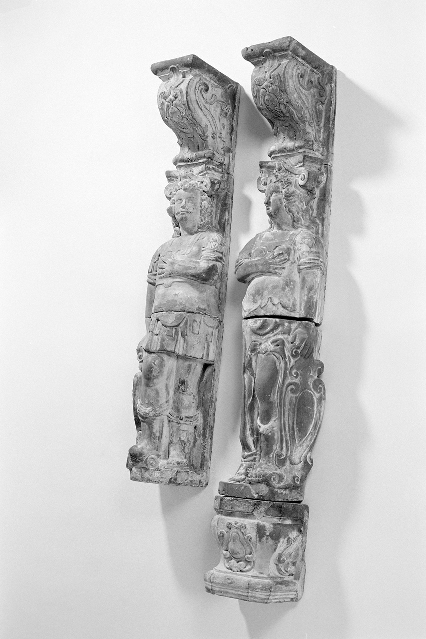 Twee schoorsteenpilasters met mannelijke en vrouwelijke figuur in Romeinse kleding